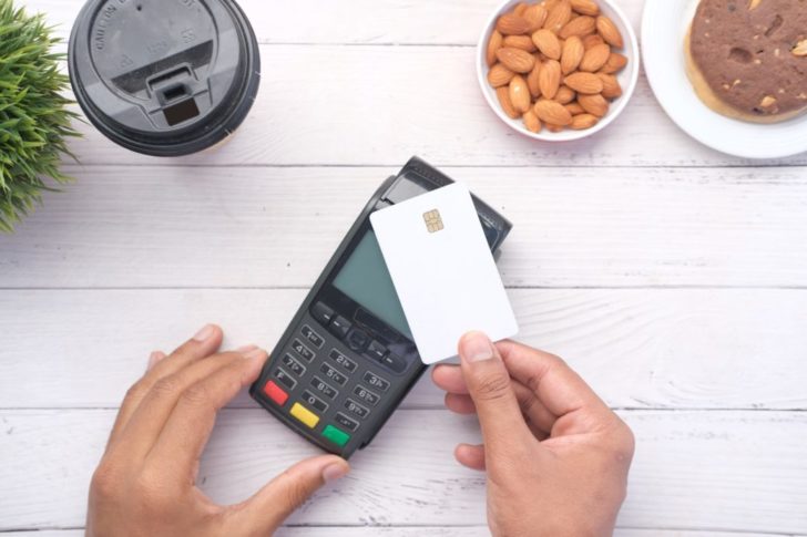 Photo by Towfiqu barbhuiya: https://www.pexels.com/photo/person-holding-credit-card-and-payment-terminal-9810169/