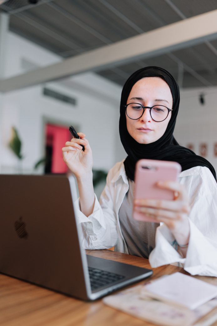 Photo by Ahmed  ツ: https://www.pexels.com/photo/young-woman-sitting-at-the-table-and-using-a-laptop-and-a-smartphone-17681377/