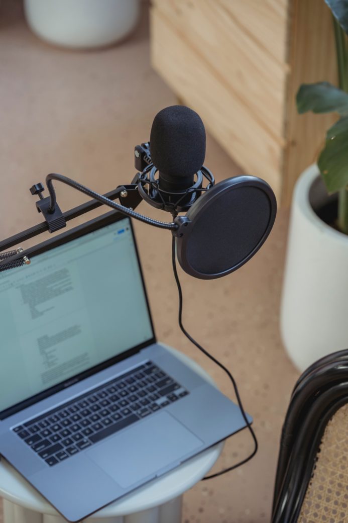 Photo by George Milton: https://www.pexels.com/photo/microphone-on-tripod-attached-to-laptop-in-studio-6953871/