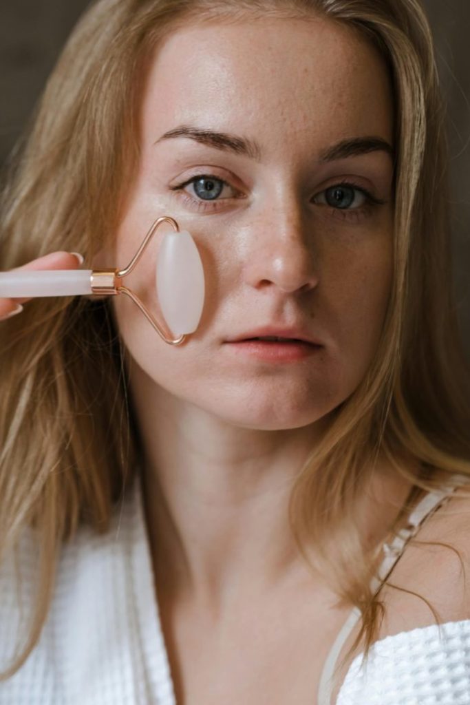 Photo by Polina Kovaleva: https://www.pexels.com/photo/a-woman-using-a-face-roller-5927932/