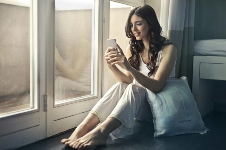 Photo by Andrea Piacquadio: https://www.pexels.com/photo/woman-sitting-beside-window-holding-phone-915051/